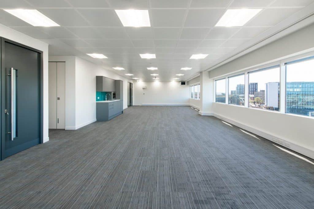 A typical upper floor at One Crown Square: open plan, suspended ceiling with recessed lighting, ribbon glazing on two elevations